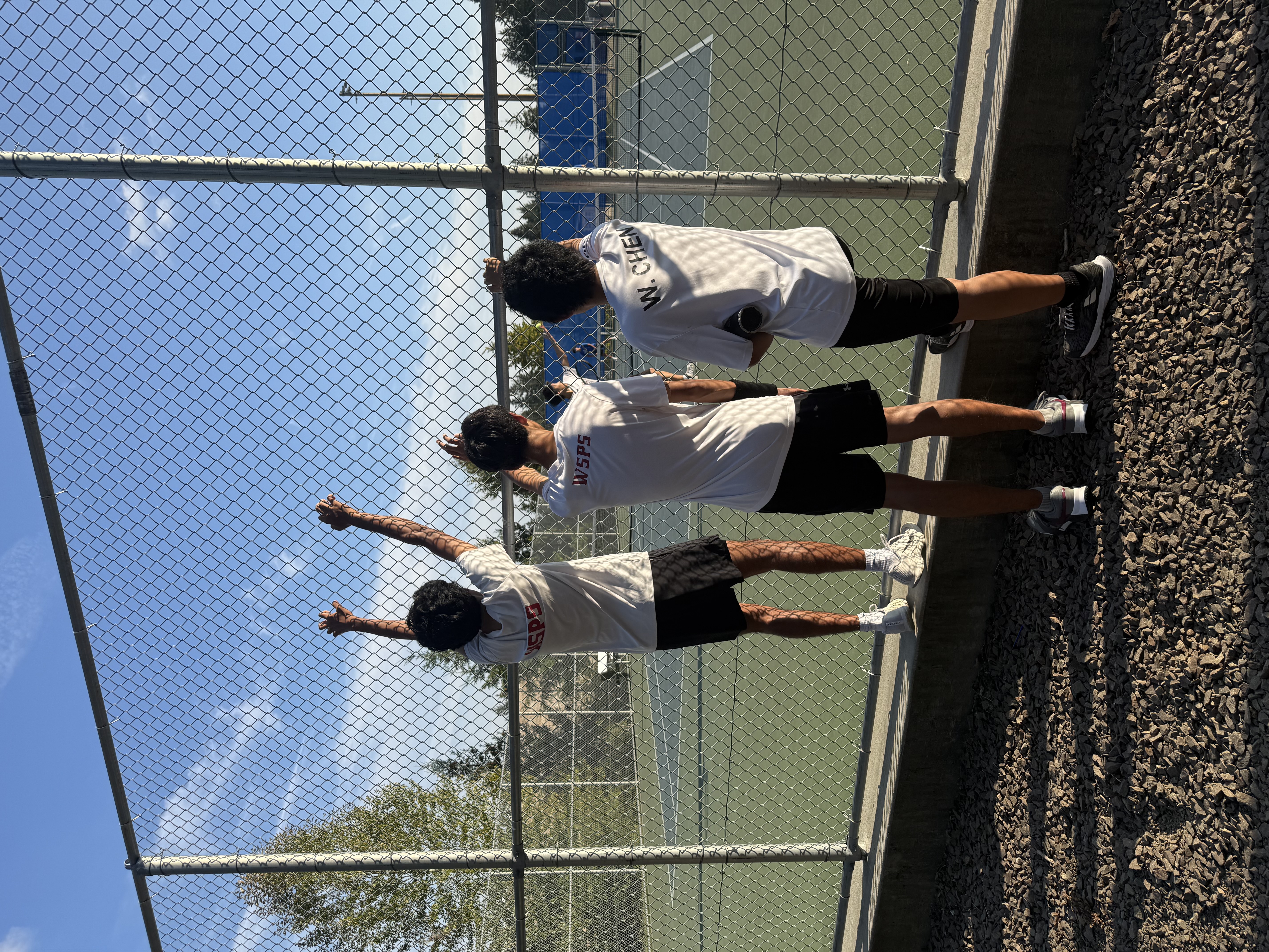 Eastlake Boys Tennis players watching a match from the fence
